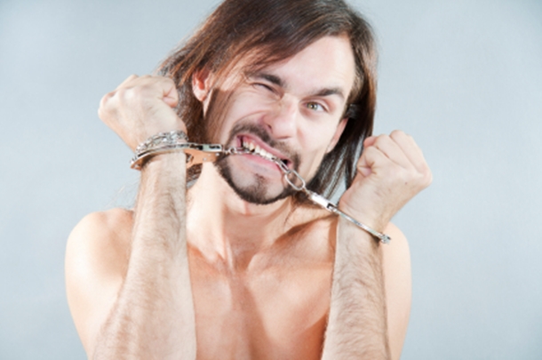 Man Biting Handcuffs