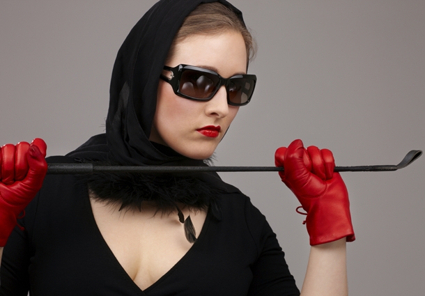 Woman wearing red leather fetish gloves.