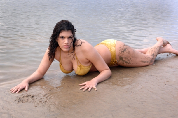 Woman with aquaphilia lying on the beach.