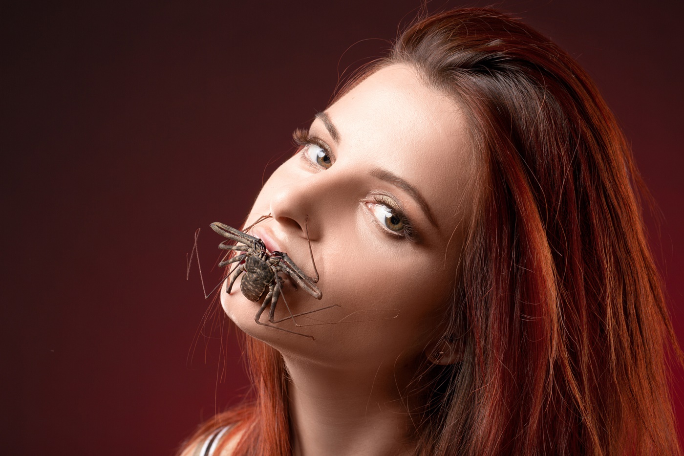 Large Insect Sitting on Woman's Mouth